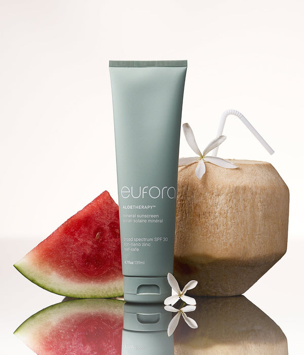 Eufora Aloetherapy SPF 30 Mineral Sunscreen 139ml tube styled with watermelon, coconut and white flowers